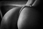string-of-pearls-lying-on-a-womans-back-and-descending-between-the-buttocks-alexandr.jpg